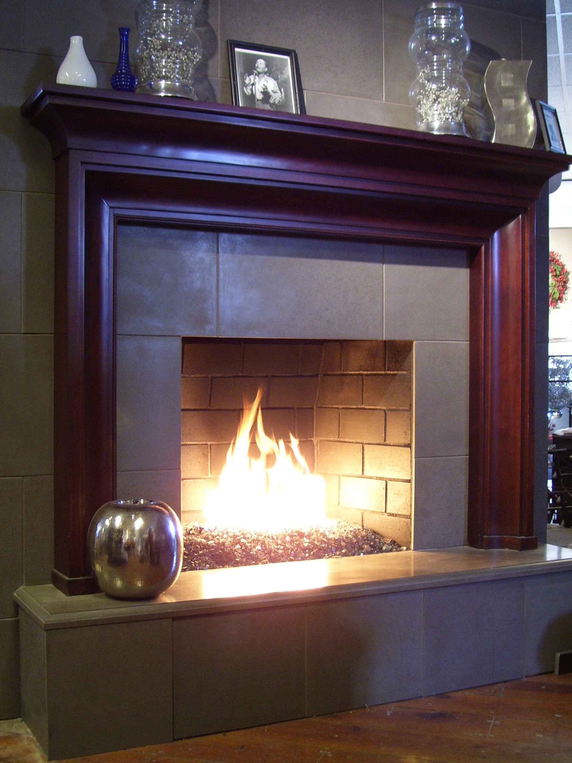 gas fireplace with stone and dark wood surround