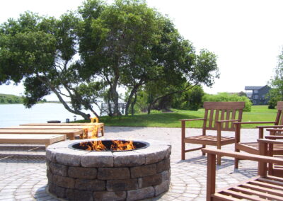 outdoor fire pit with stone surround on river side backyard