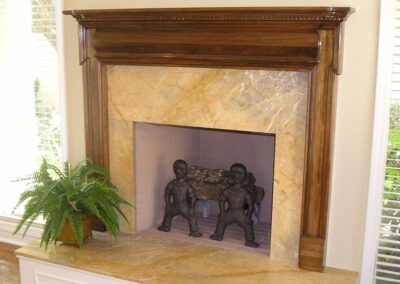 new fireplace construction after with marble surround and darkwood mantel