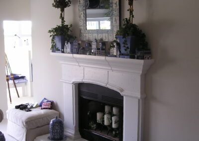 new gas fireplace in living room with white surround