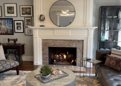 new gas fireplace in living room with white mantel and brick surround