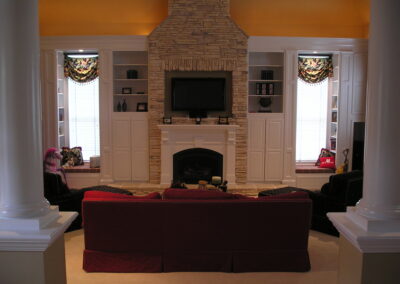 new gas fireplace in living room with white wooden mantel and brick surround