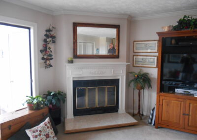 new gas fireplace in living room with stone surround