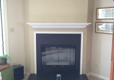 new gas fireplace in living room with white wooden mantel