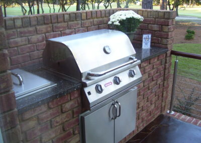 outdoor kitchen on back porch with built-in grill