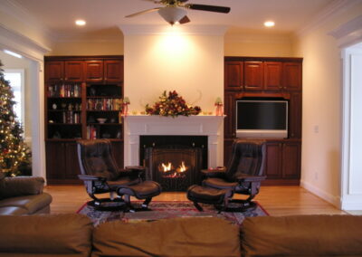 new gas fireplace in living room with white wood mantel and surround