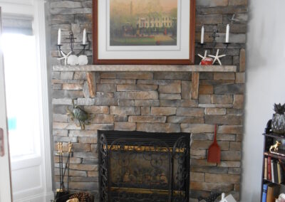 new gas fireplace in living room with stone surround