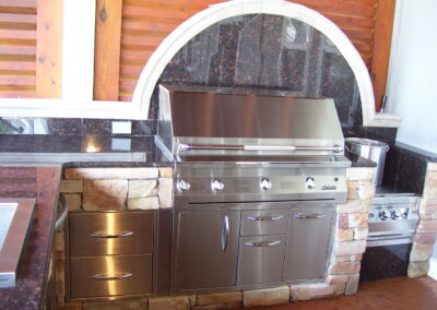 outdoor kitchen on back porch with built-in grill