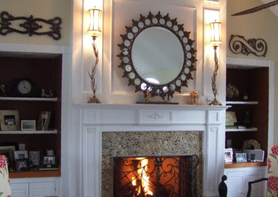 new gas fireplace in living room with white wood mantel and stone surround