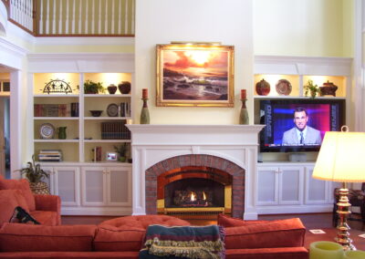 new gas fireplace in living room with white wood surround and mantel