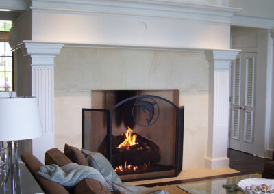 indoor fireplaces with white stone surround and black screen