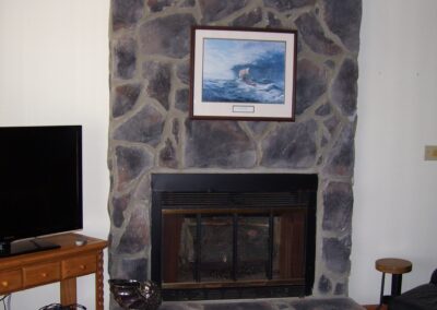 Replacing old fireplace with new gas fireplace in living room with stone surround