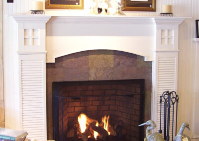 gas fireplace with stone and white wood surround
