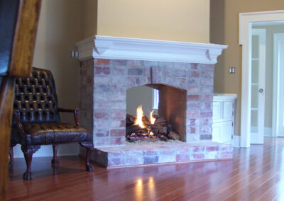 see through gas fireplace with stone surround