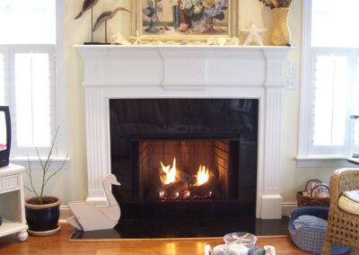 gas fireplace with metal and white wood surround
