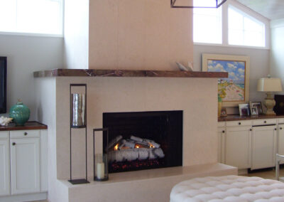 gas fireplace with white surround and wood mantel